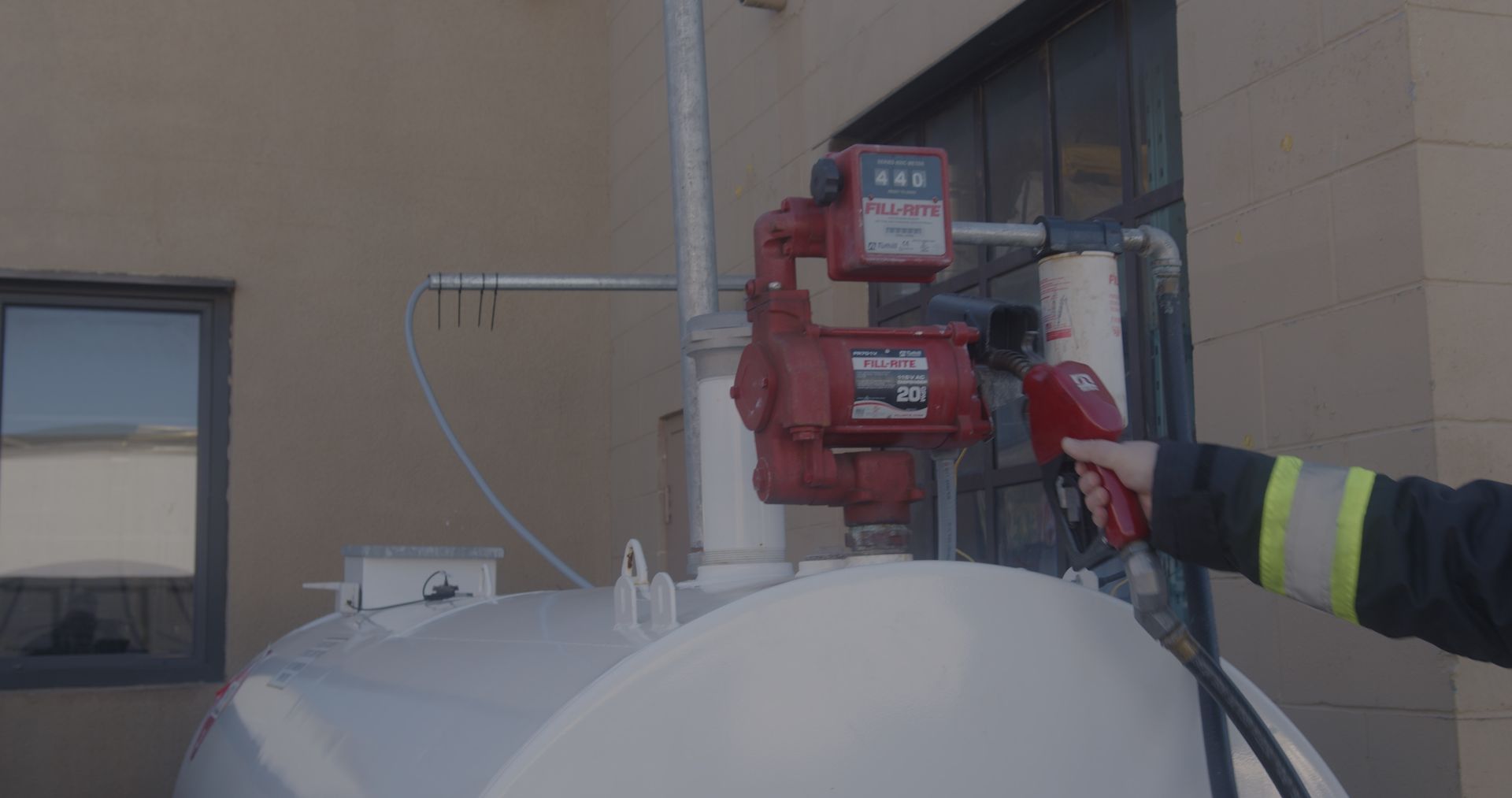 A fireman is pumping gas into a tank.