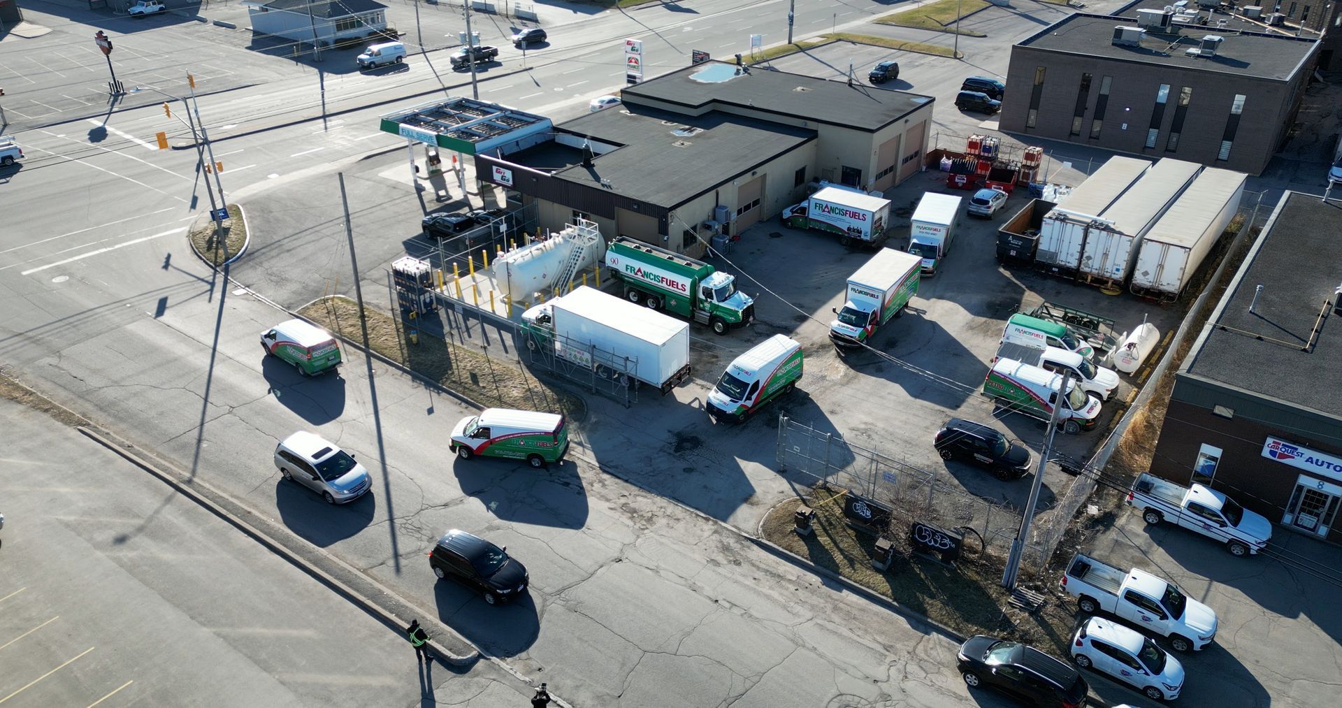 An aerial view of a parking lot filled with trucks and cars.