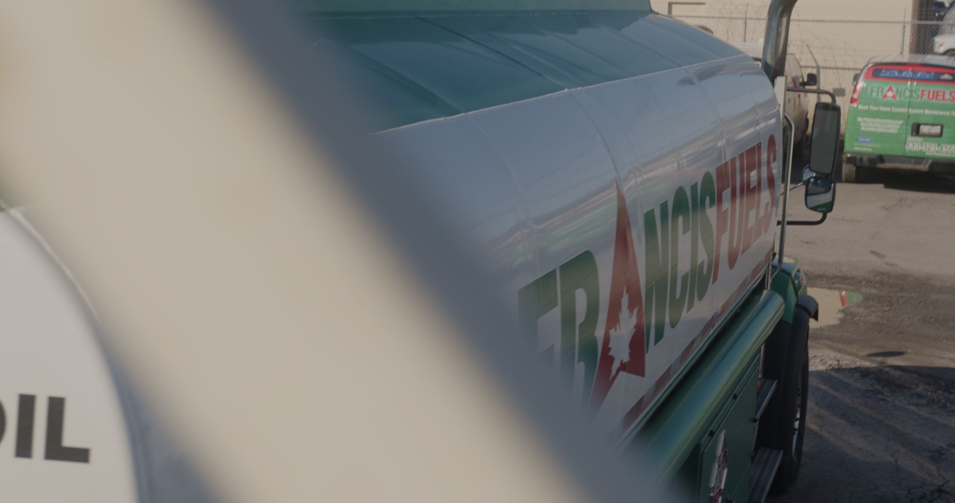 A tanker truck is parked on the side of the road.