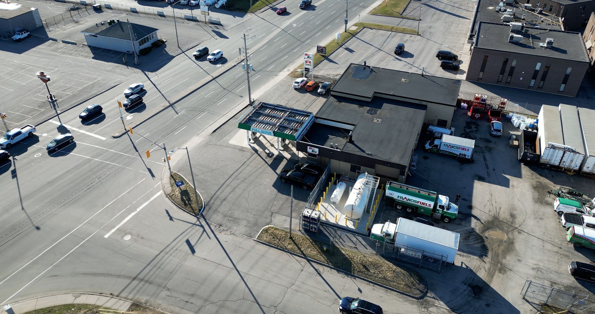 An aerial view of a parking lot filled with trucks and cars.