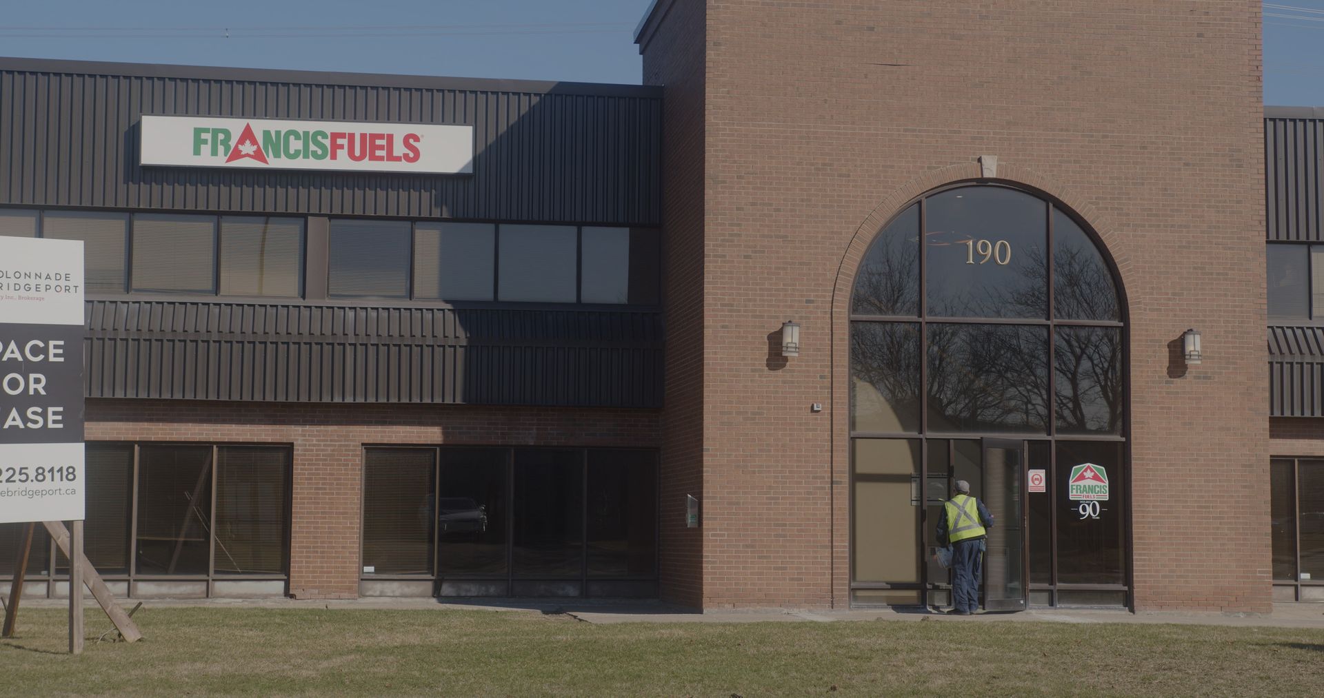 A brick building with a sign that says francis fuels