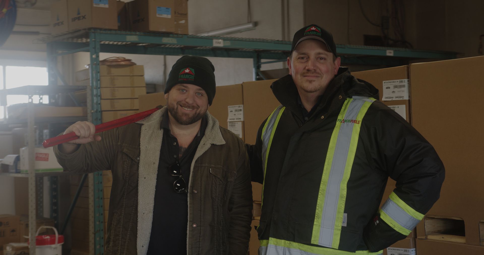 Two men are standing next to each other in a warehouse.