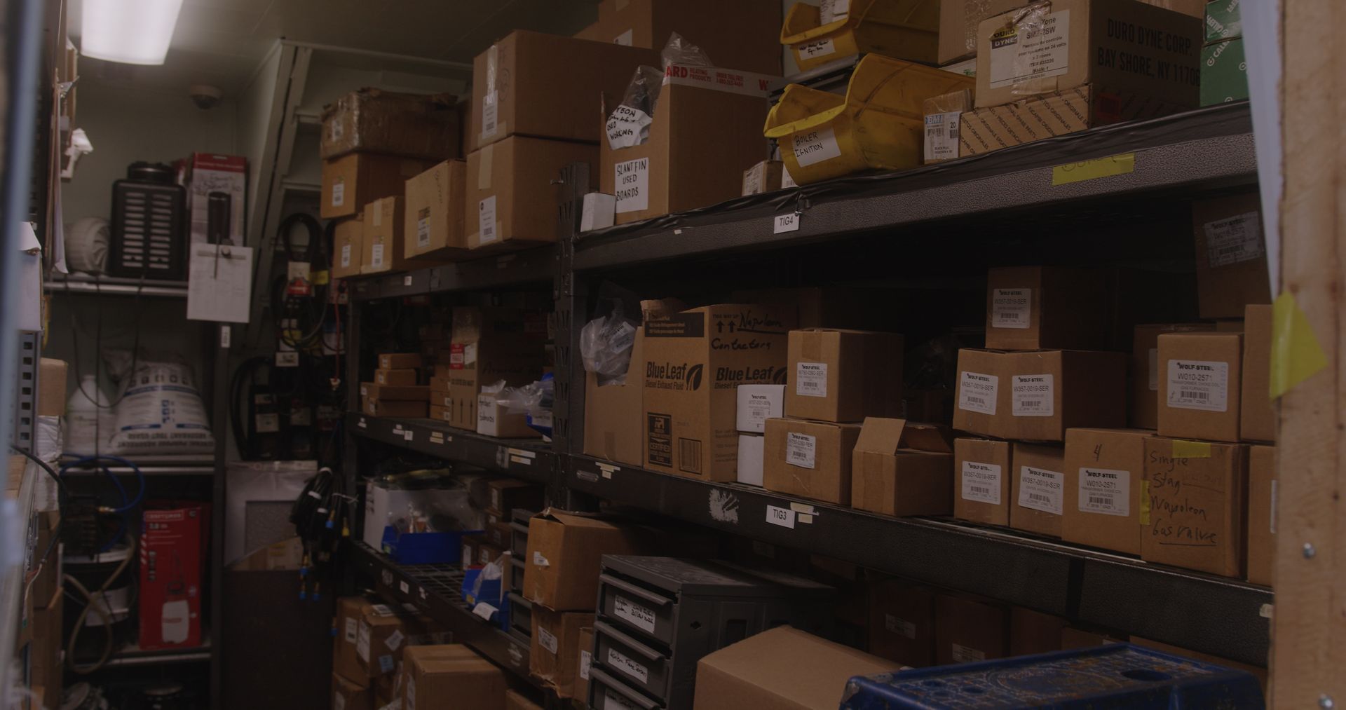 A warehouse filled with lots of boxes on shelves.