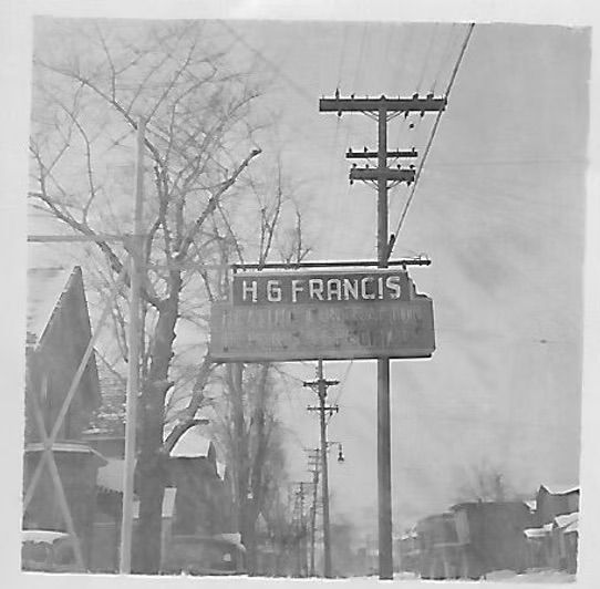 A black and white photo of a sign that says hg francis