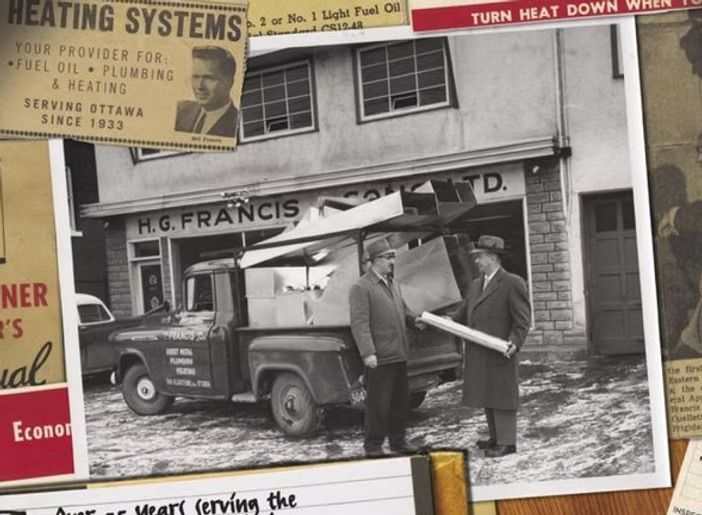 Two men standing in front of a building that says heating systems