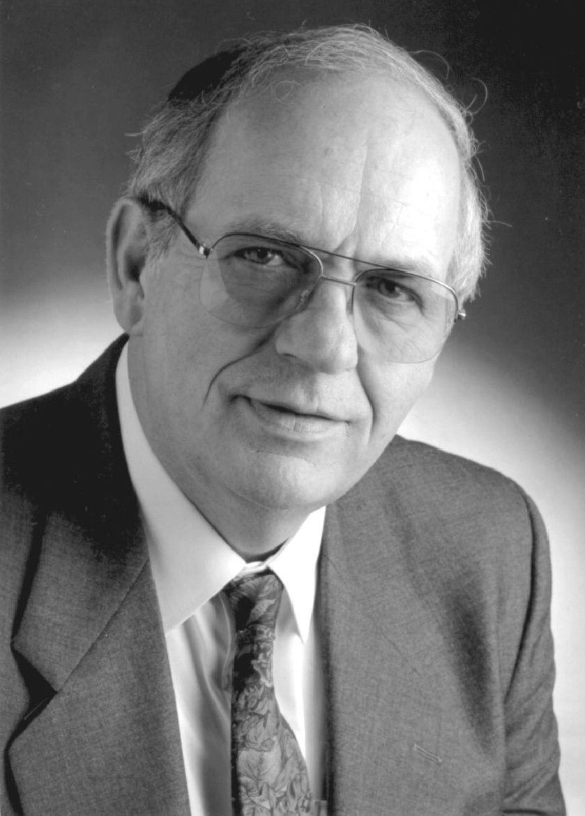 A black and white photo of a man in a suit and tie