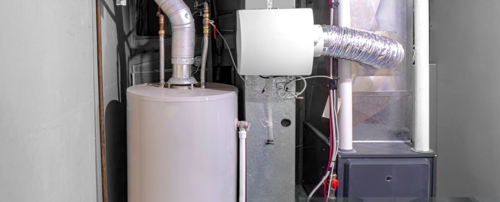 A water heater and a furnace are sitting inside of a house.