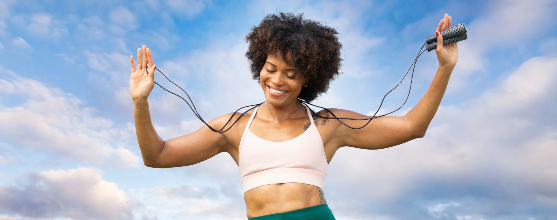A woman is jumping a jump rope in the air.