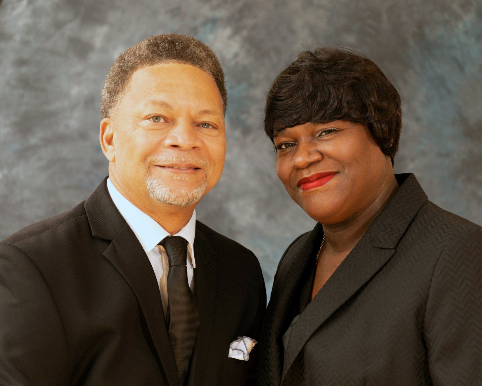 A man and a woman are posing for a picture together
