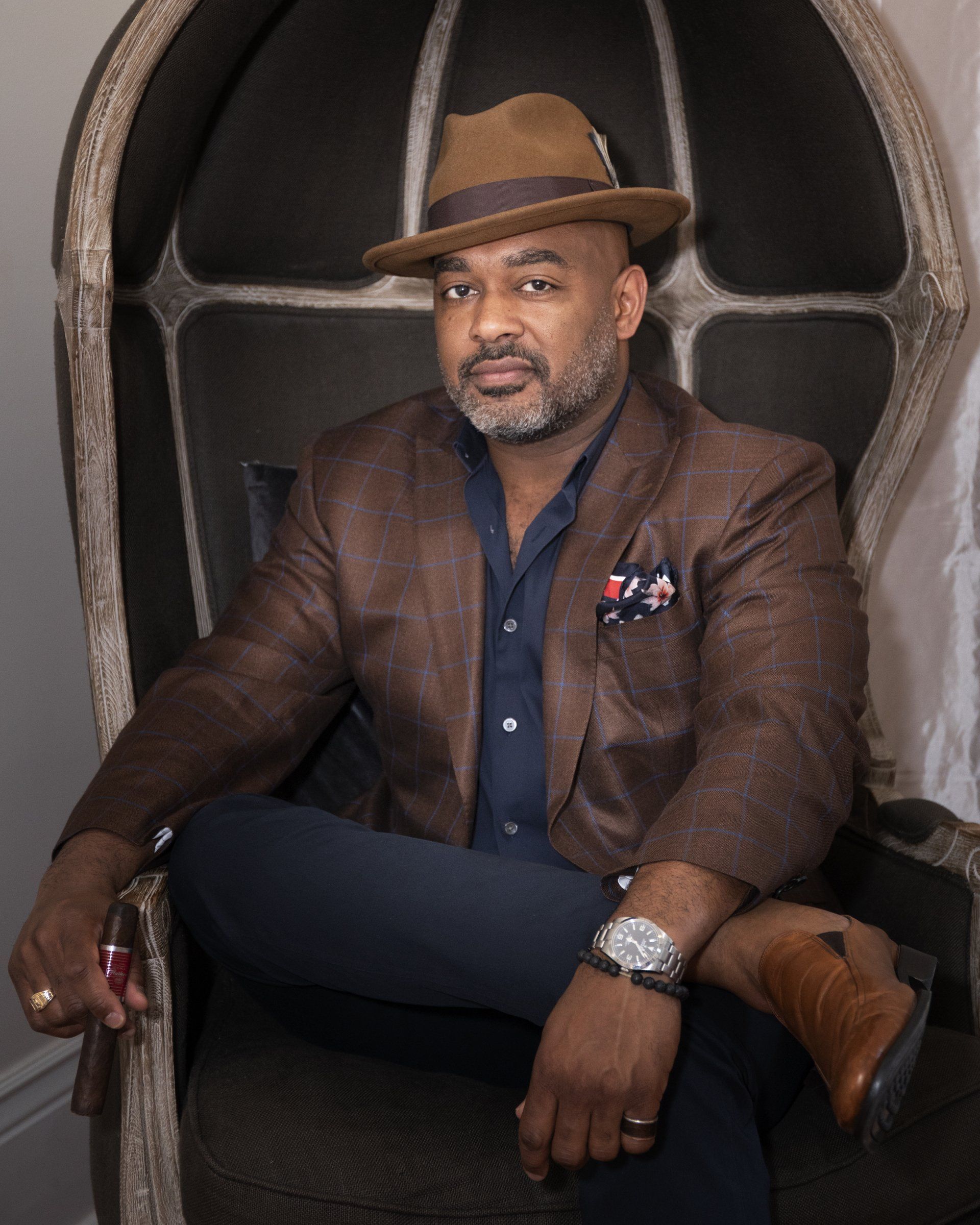 A man wearing a hat is sitting in a chair