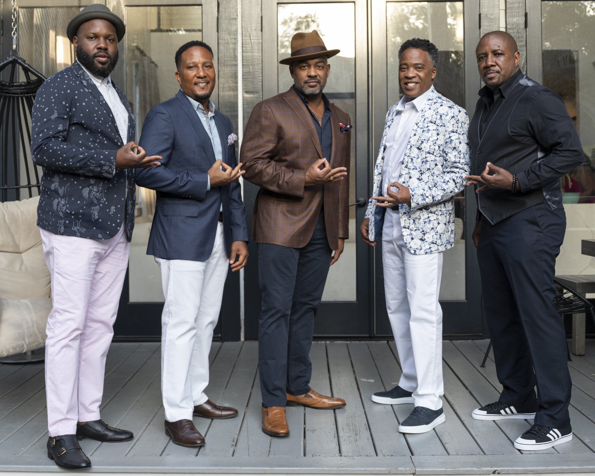 A group of men are standing next to each other on a deck.