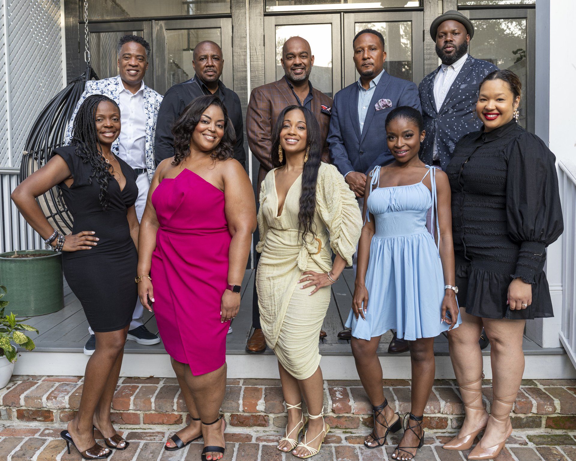 A group of people are posing for a picture in front of a building.