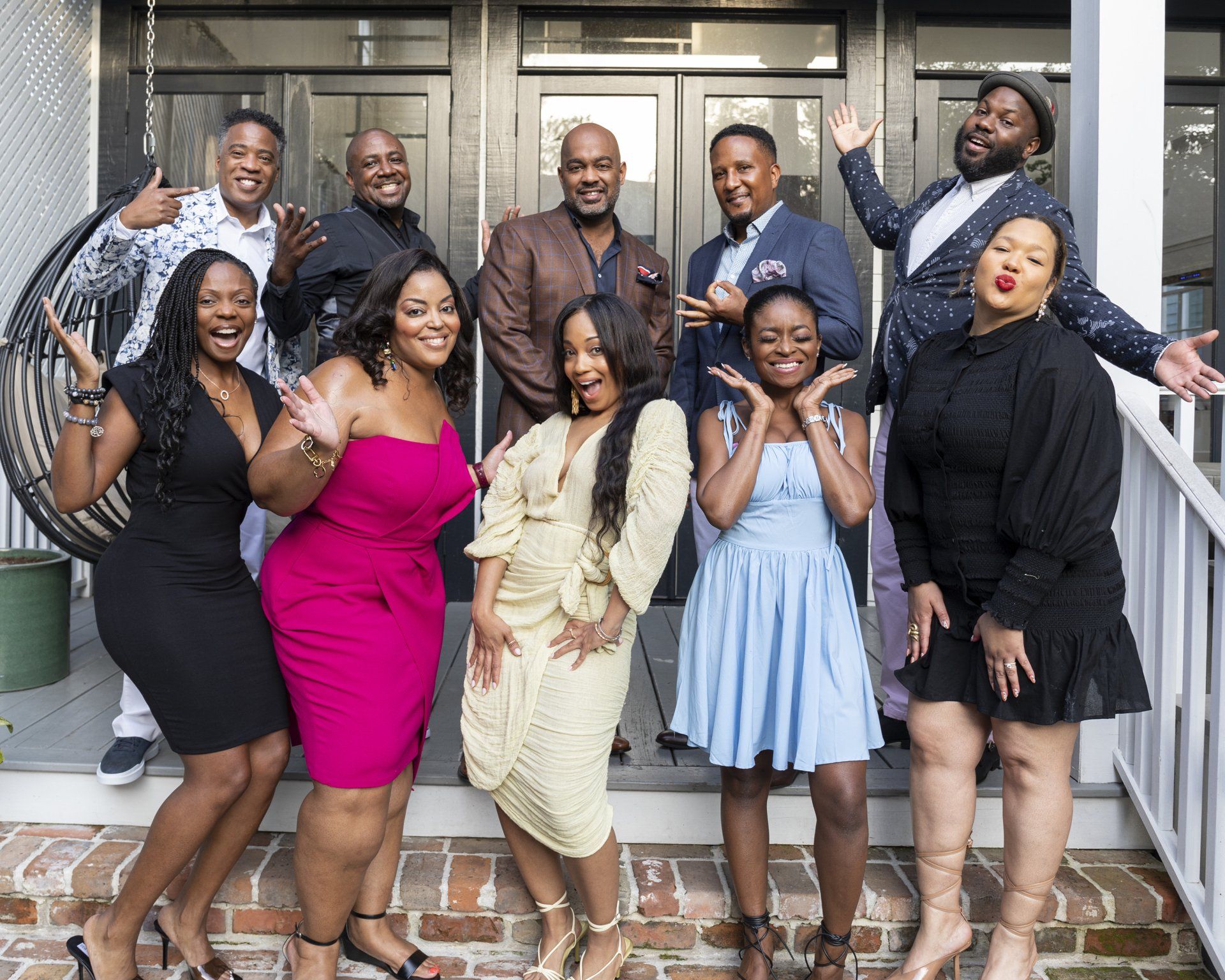 A group of people are posing for a picture in front of a building.