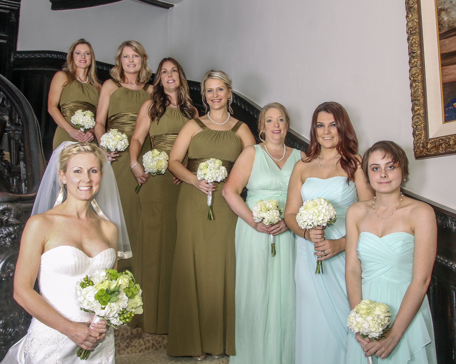 A bride and her bridesmaids are posing for a picture