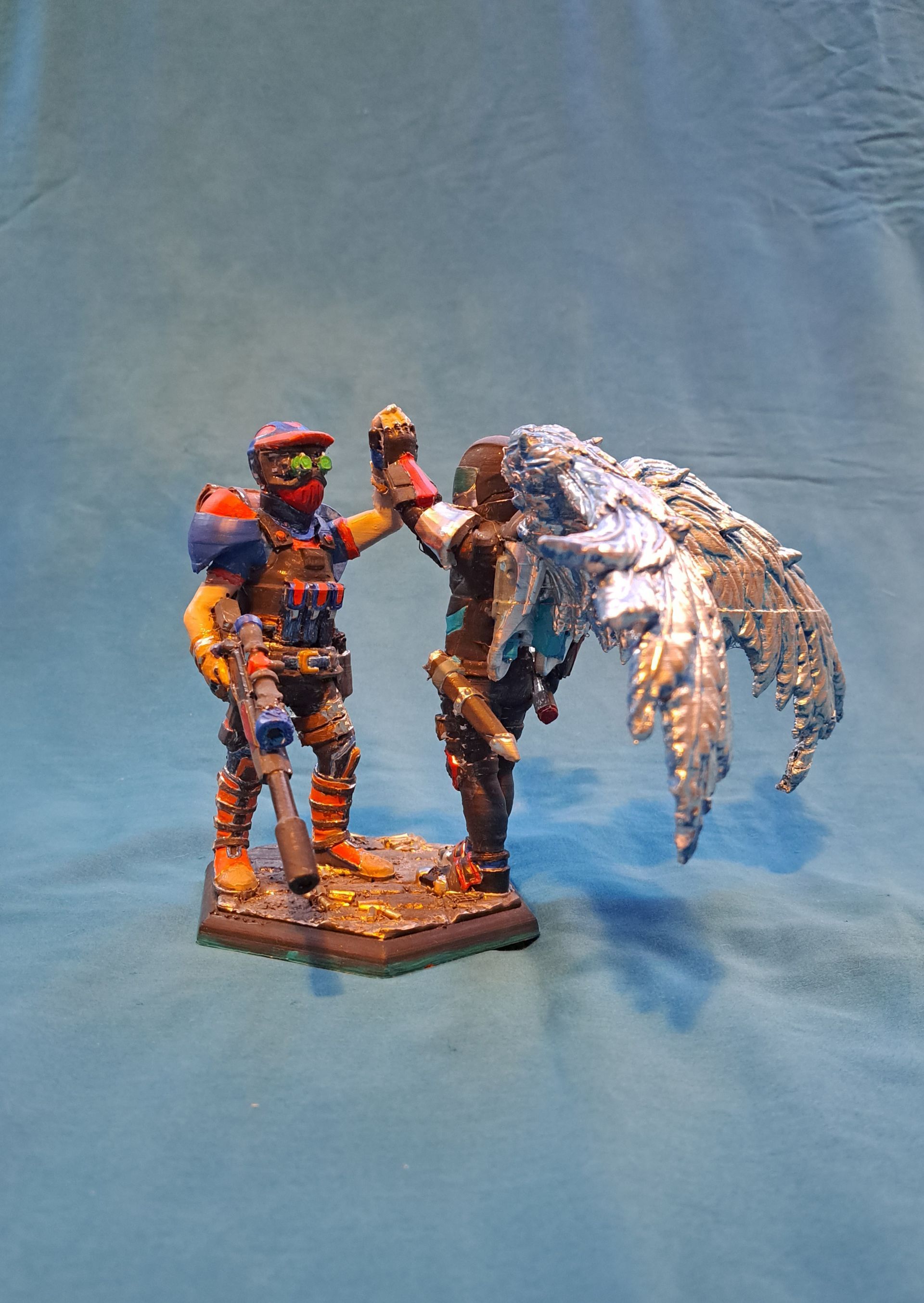 Two figurines High fiving alternate angle