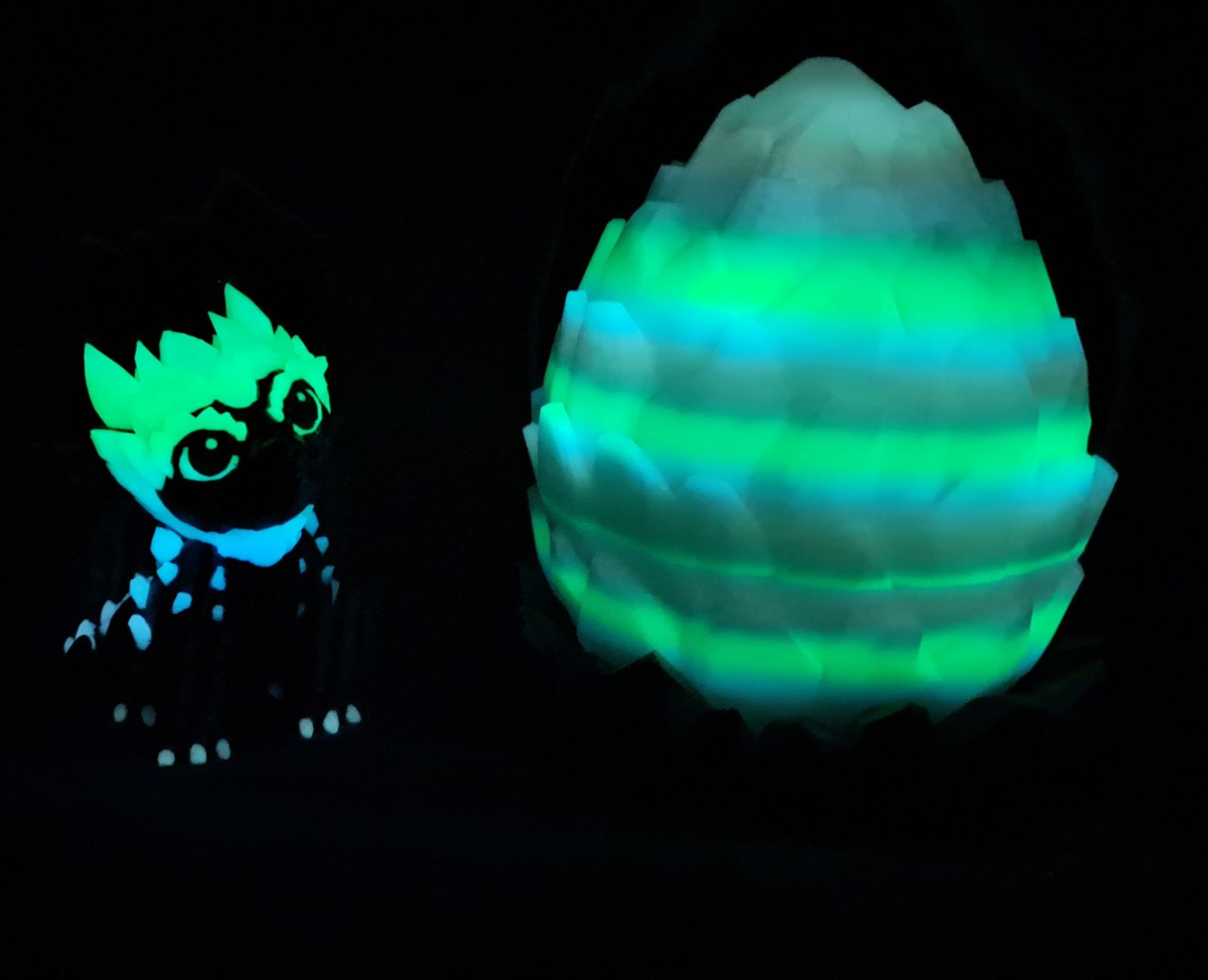 3D-printed dragon figurine with a crystal egg on a color changing, faceted base.