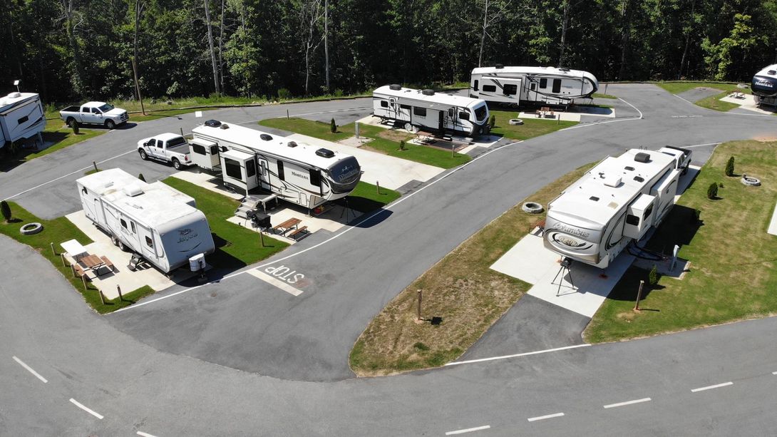 An aerial view of a rv park with a lot of rvs parked in it.