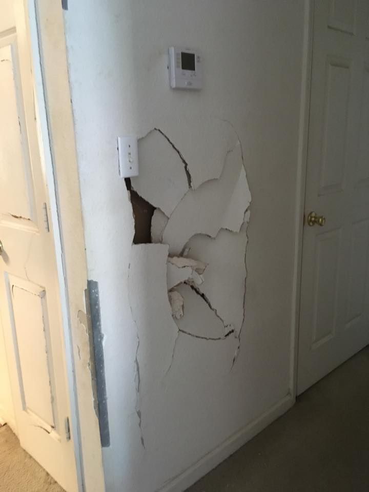 A wall with a hole in it that needs repair.