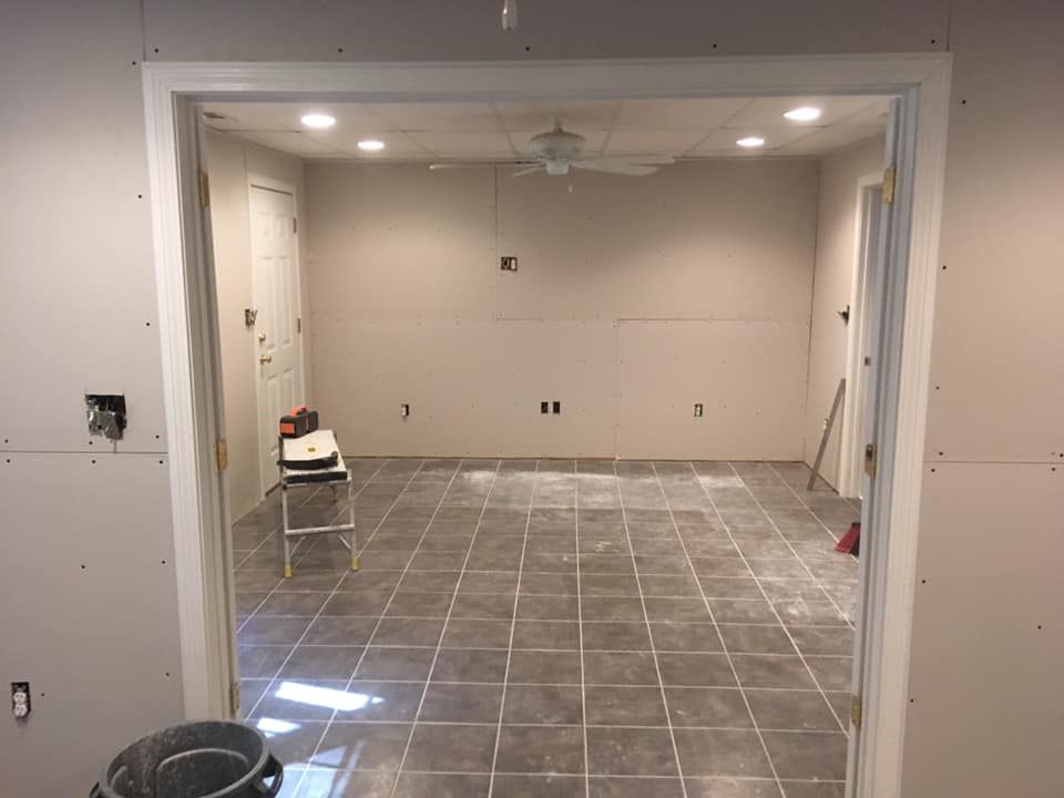 A room with tile floors and a ceiling fan.