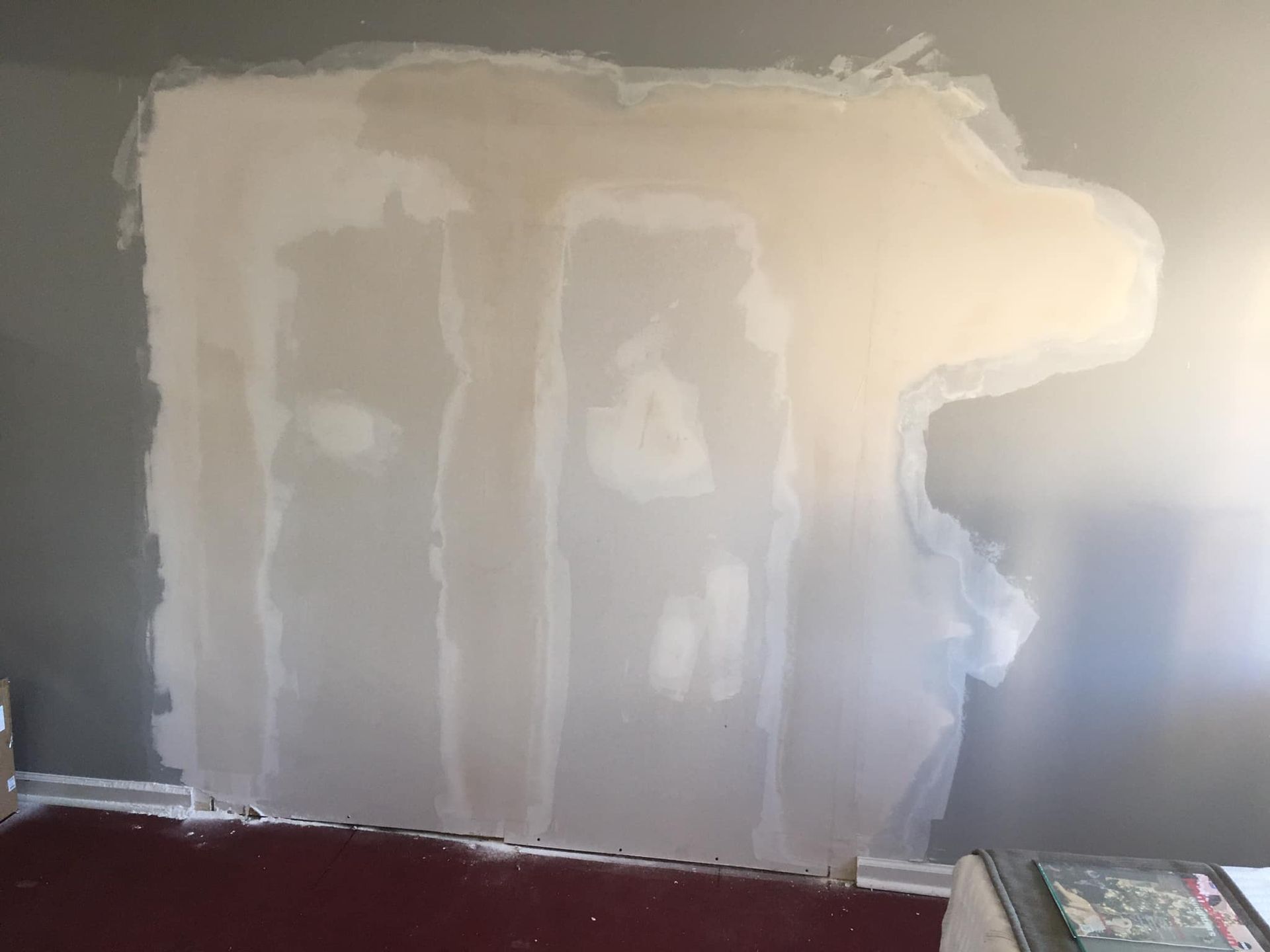 A wall is with a large drywall repair.