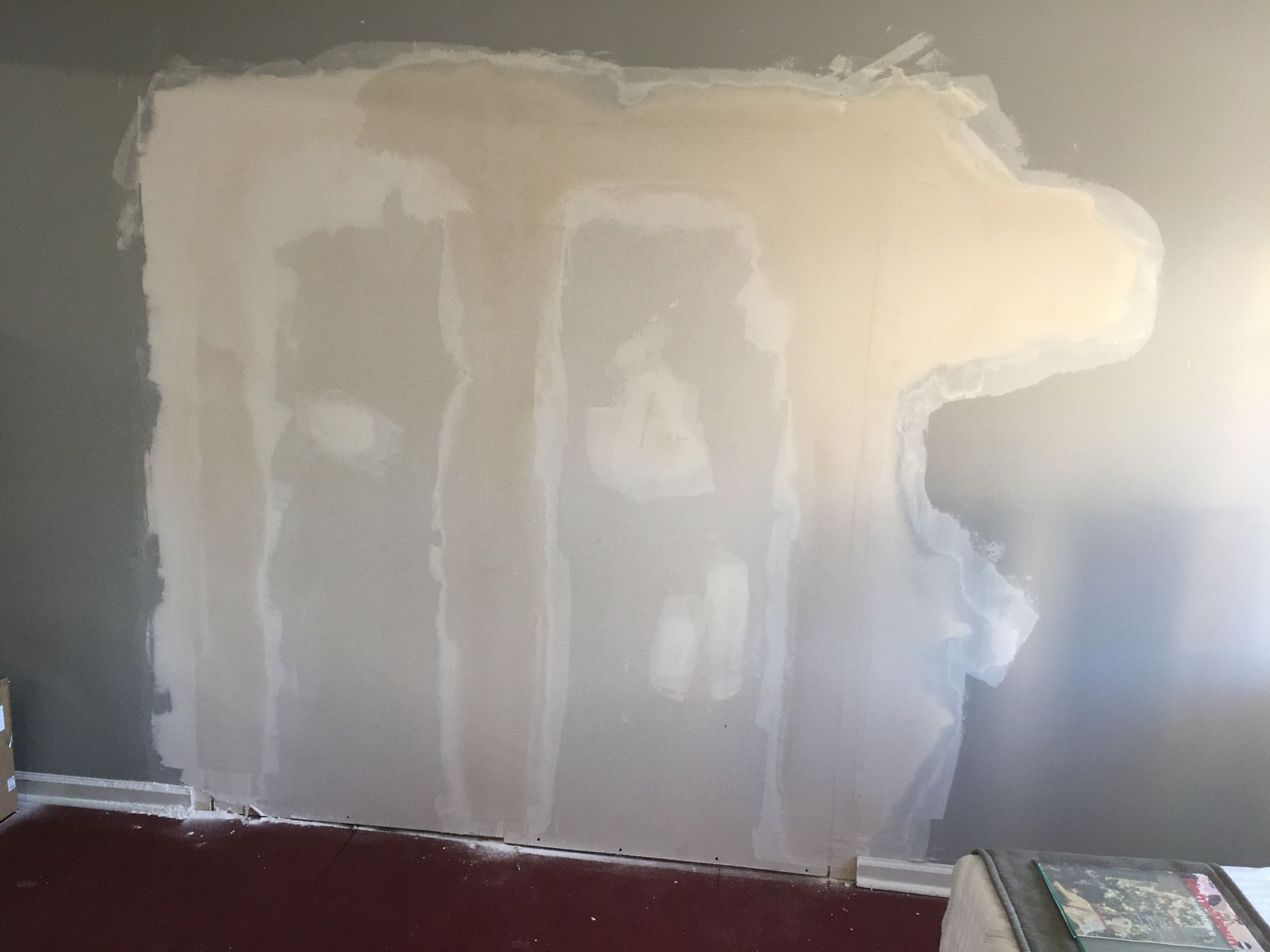 A wall is with a large drywall repair.