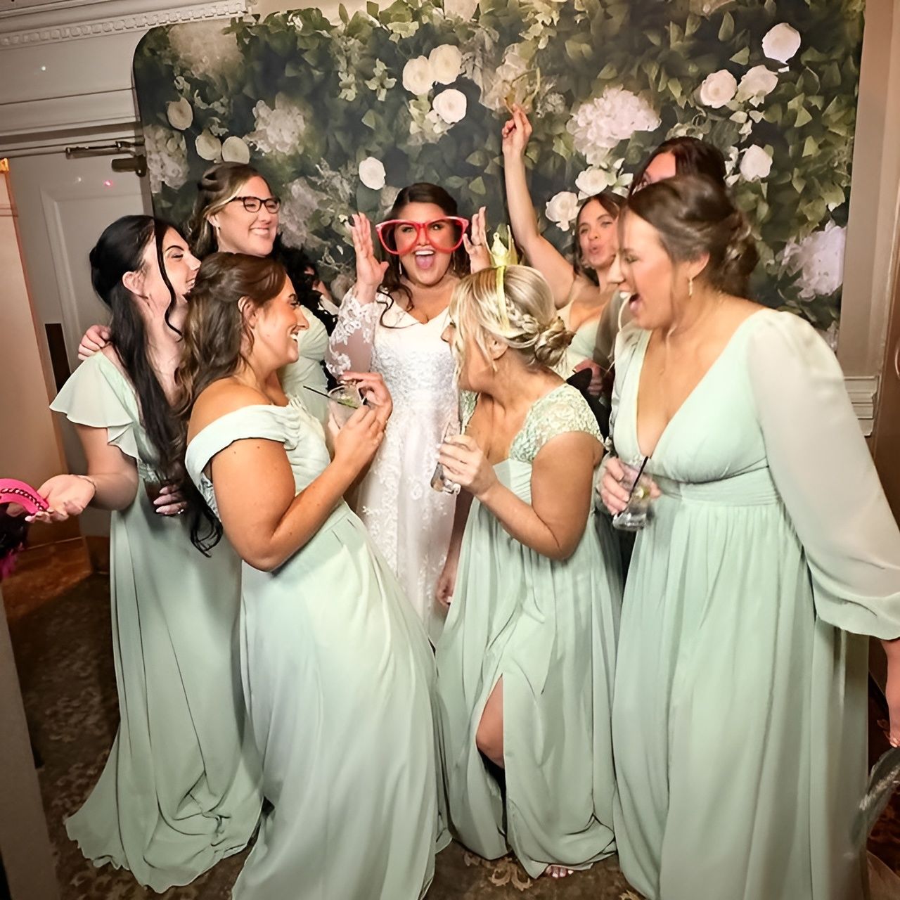 A bride and her bridesmaids are posing for a picture.