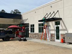 The Moon Metal Works crew installing architectural aluminum canopies.