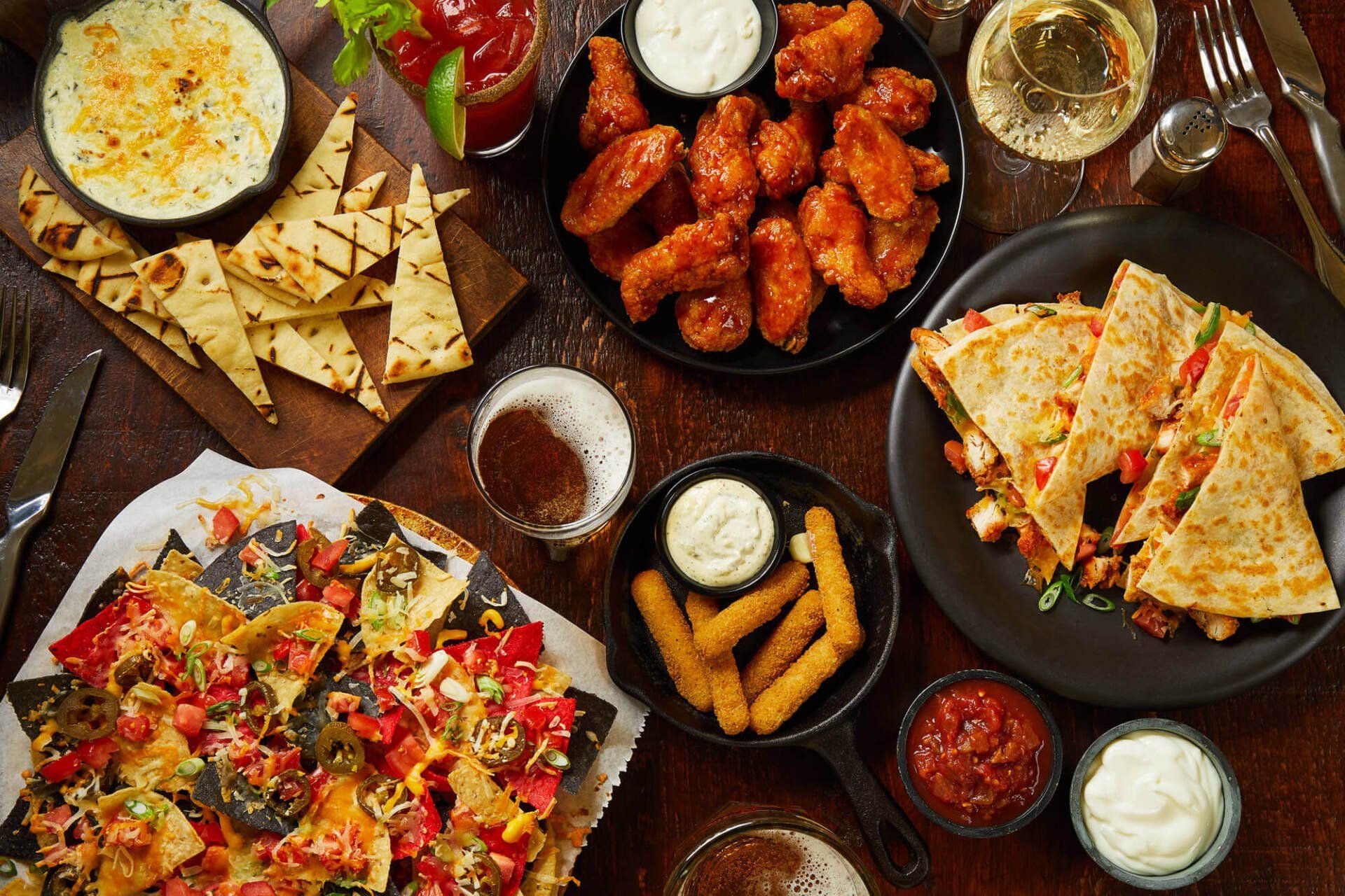 A table topped with plates of food and drinks.