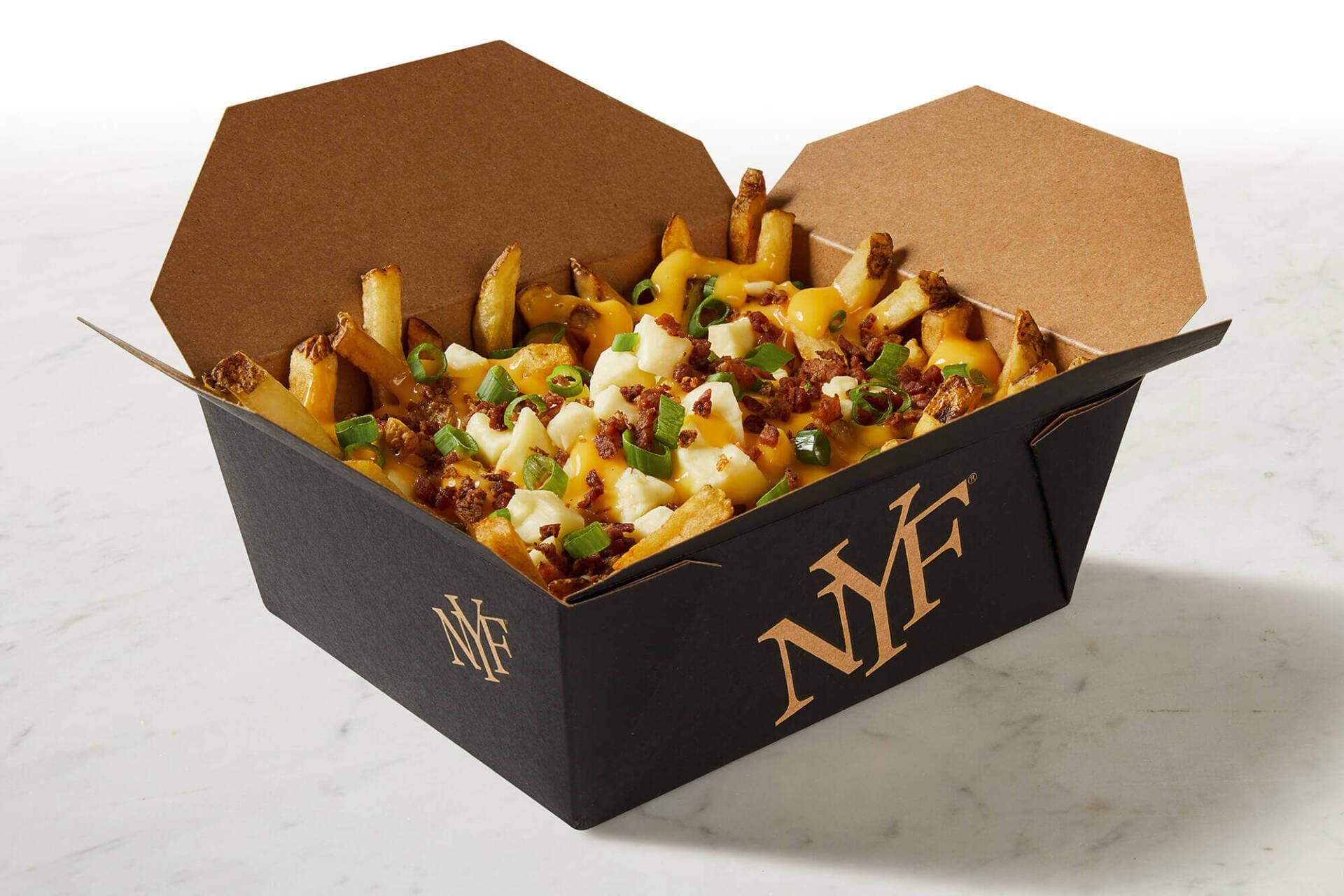 A black box filled with french fries and cheese