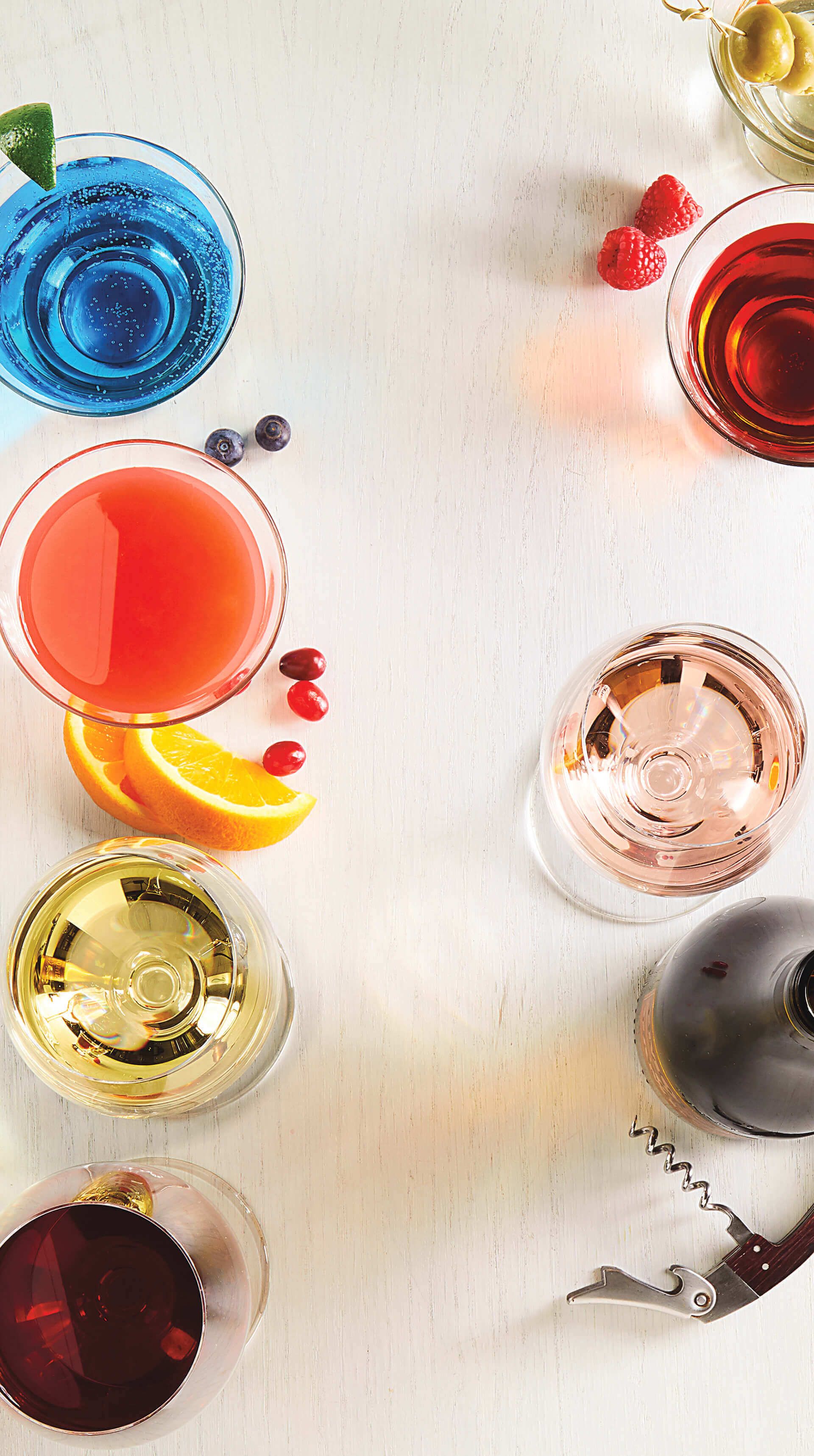 A table topped with a variety of drinks and a corkscrew.