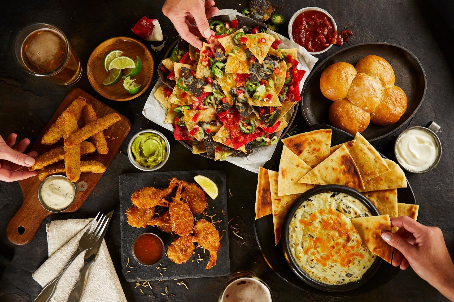 A table topped with plates of food and drinks.