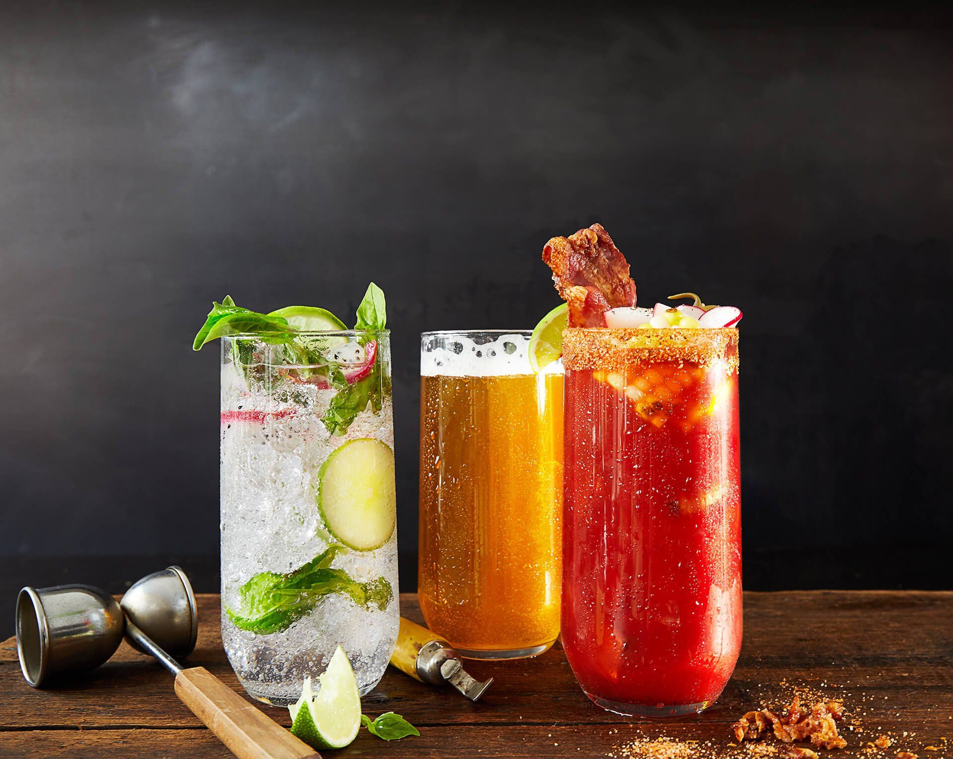 Three different types of drinks are sitting on a wooden table.