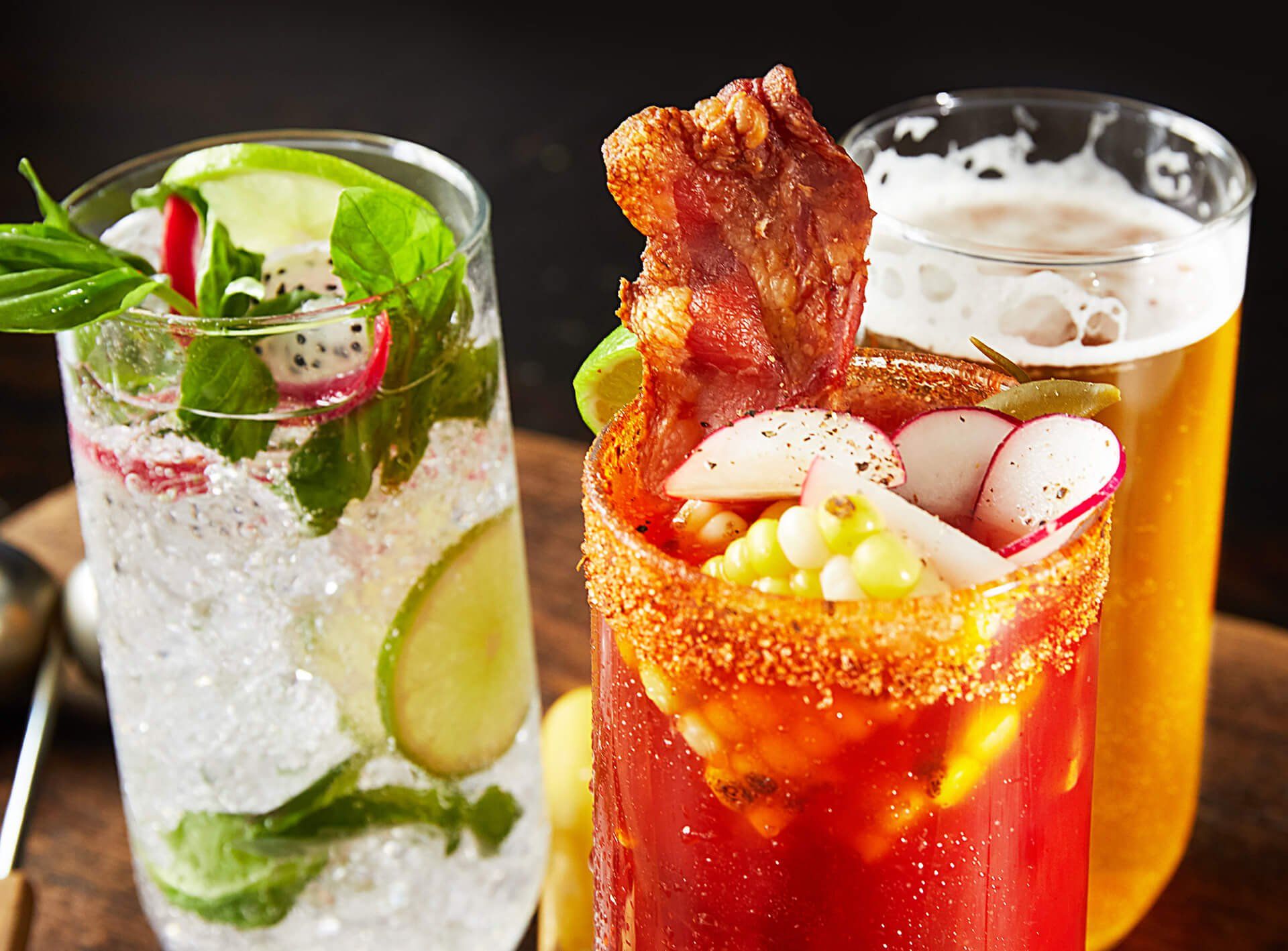 Three different types of drinks are sitting on a wooden table.