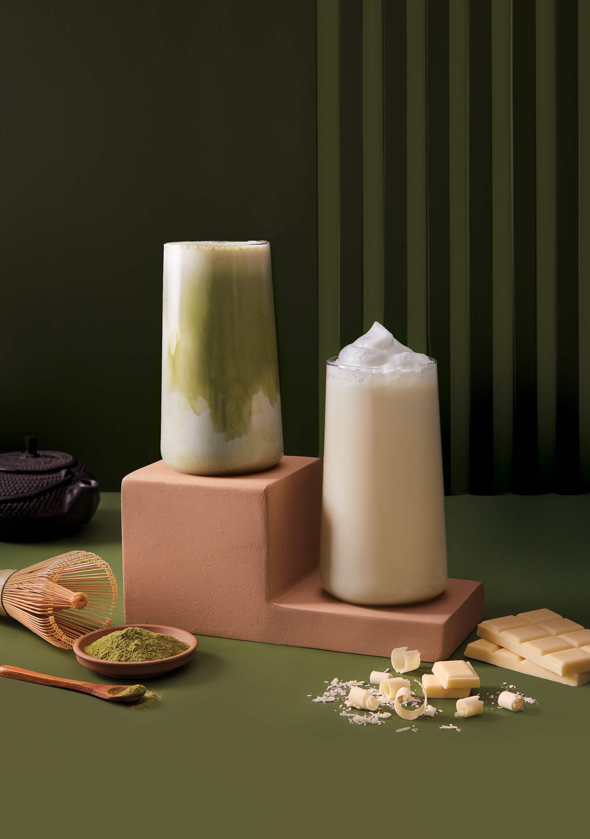 Two candles are sitting on top of a table next to each other.