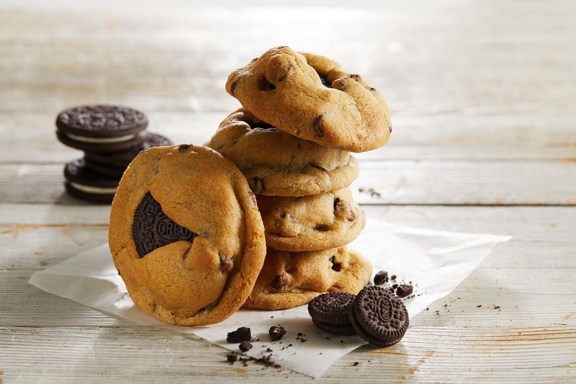 A stack of oreo cookies on a wooden table.