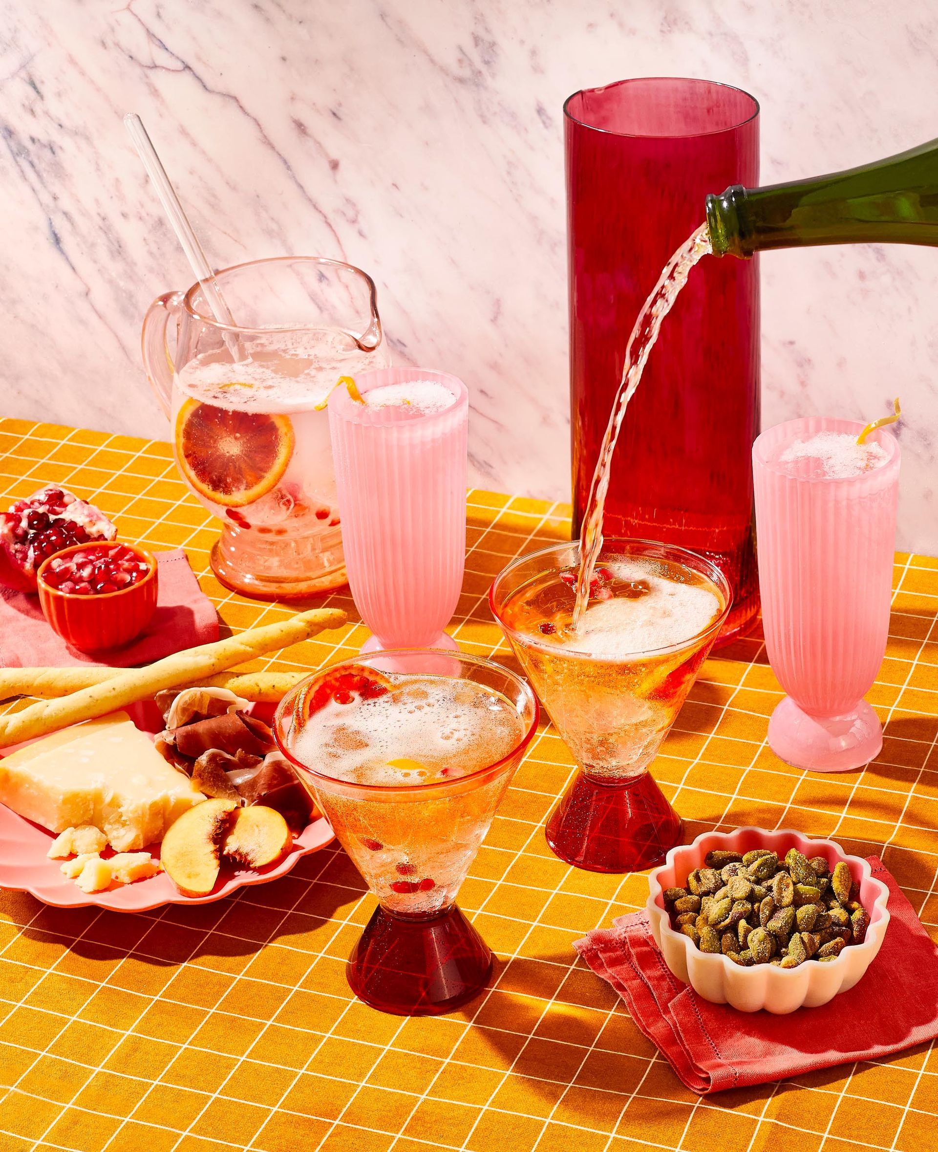 A bottle of sangria is being poured into a glass on a table.