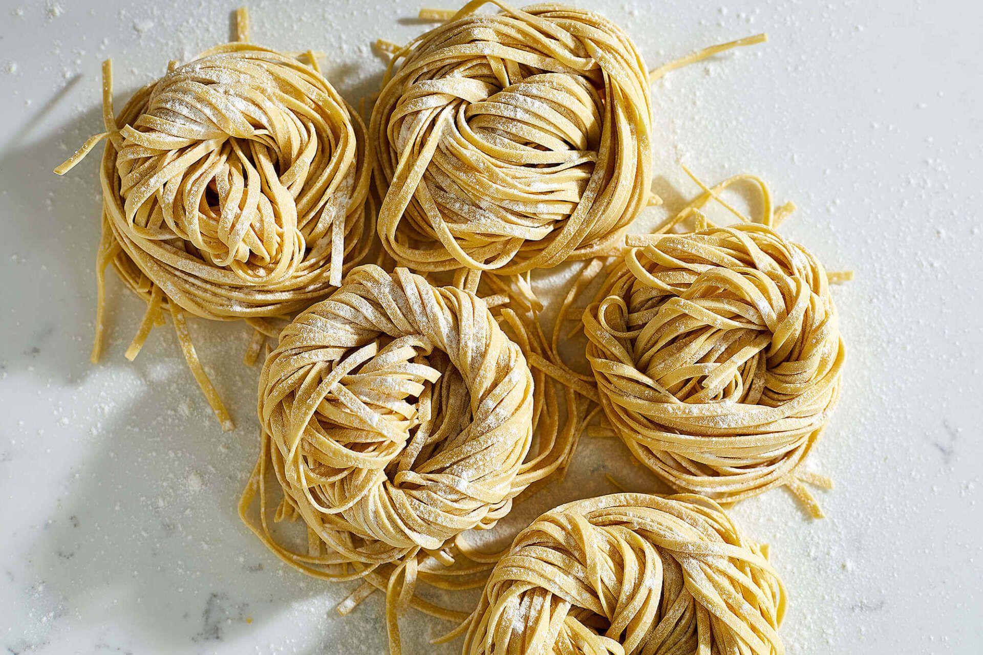 A bunch of noodles are sitting on top of each other on a table.