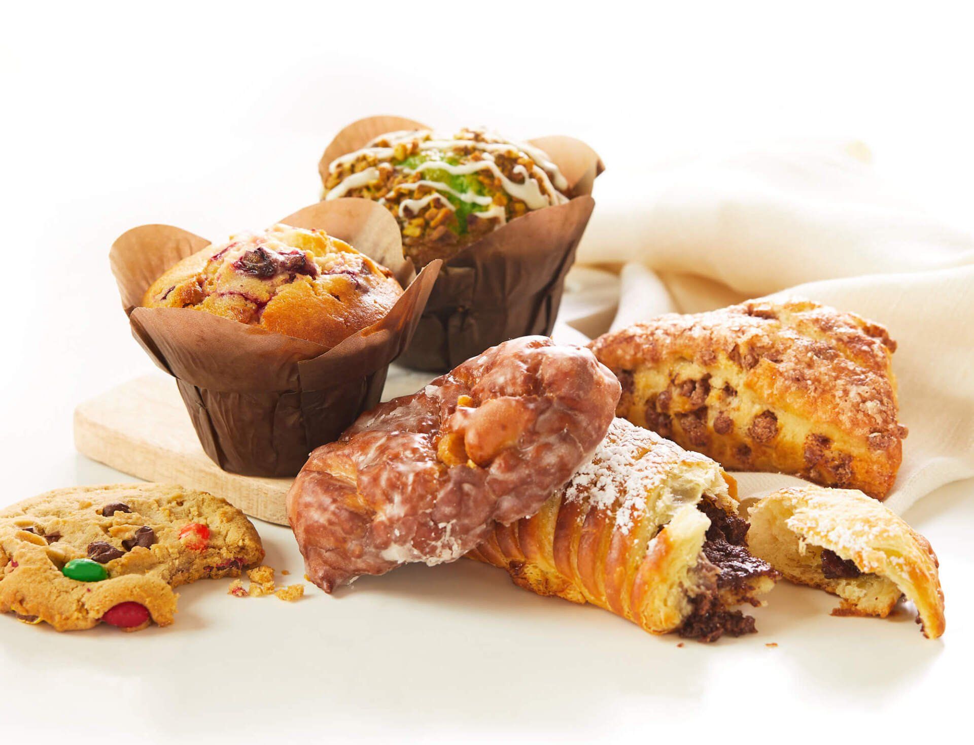 A variety of pastries and muffins are on a table