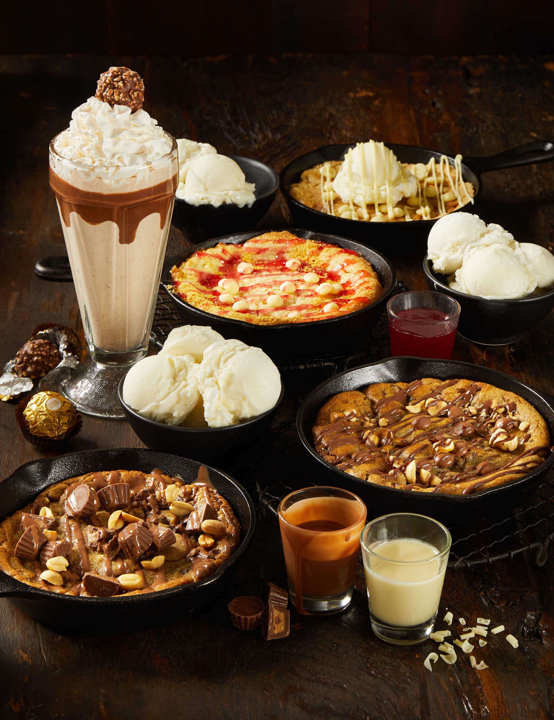 A table topped with a variety of desserts and drinks.