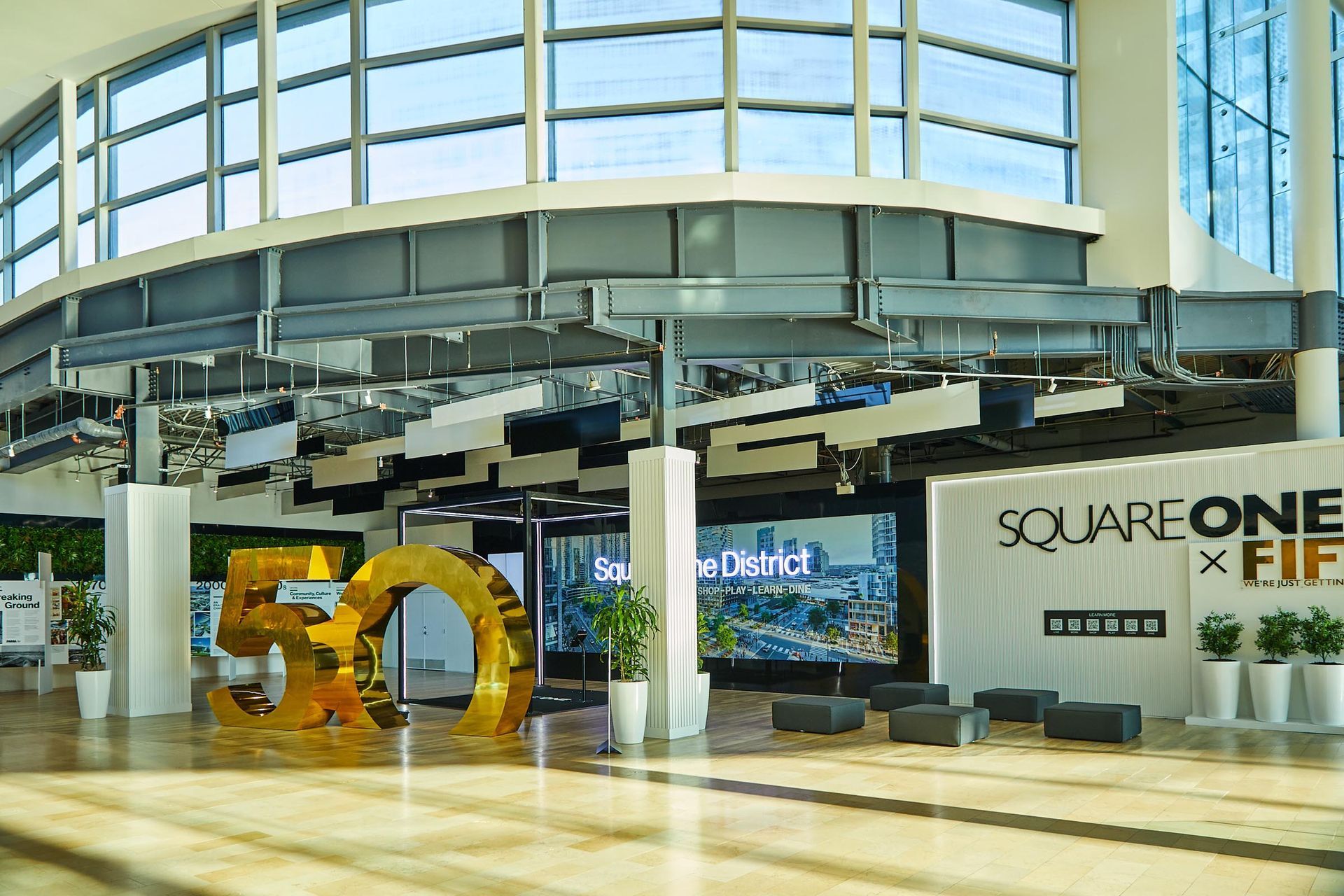 A large building with a sign that says square one on it