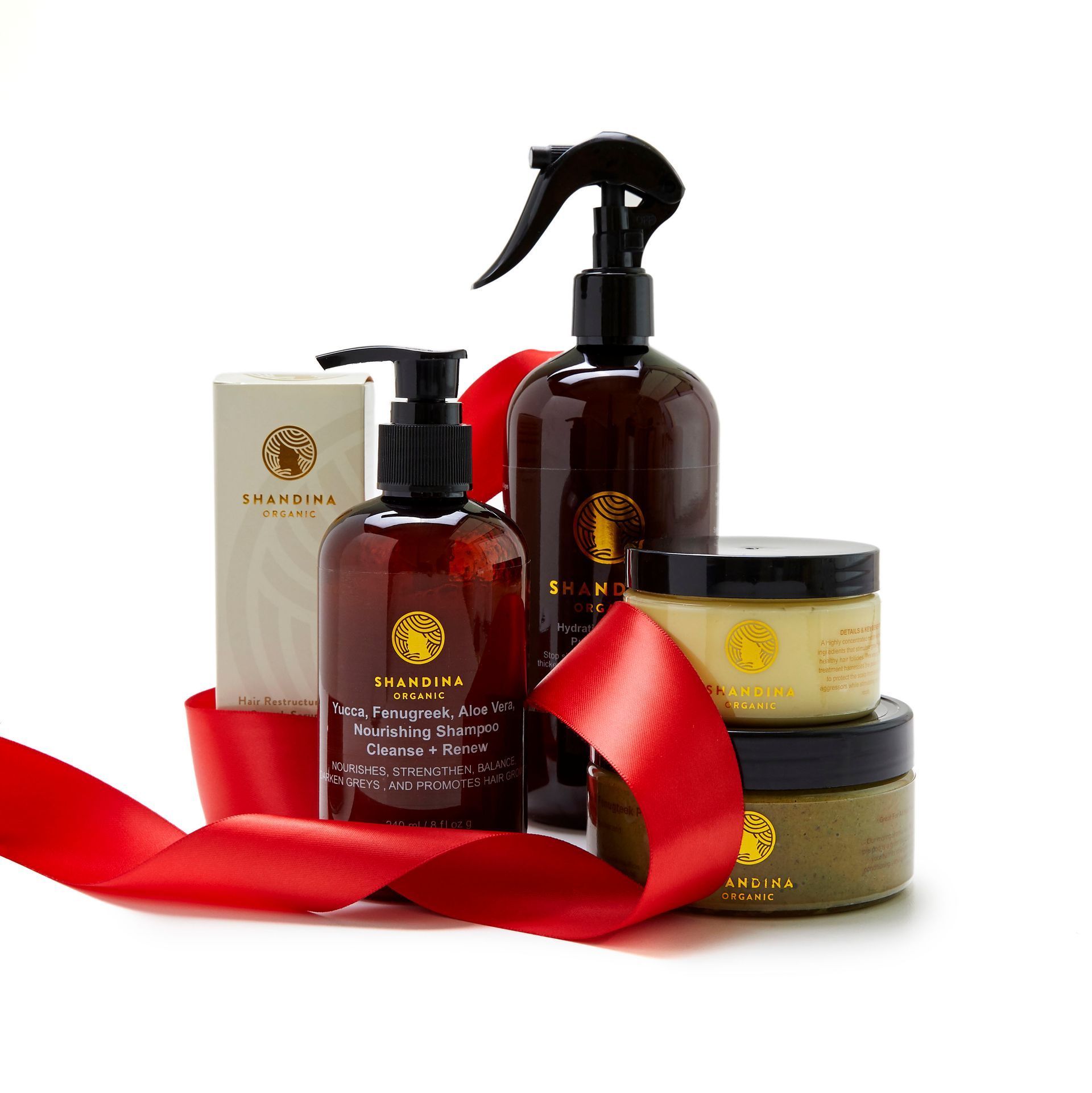 A group of bottles and jars with a red ribbon around them