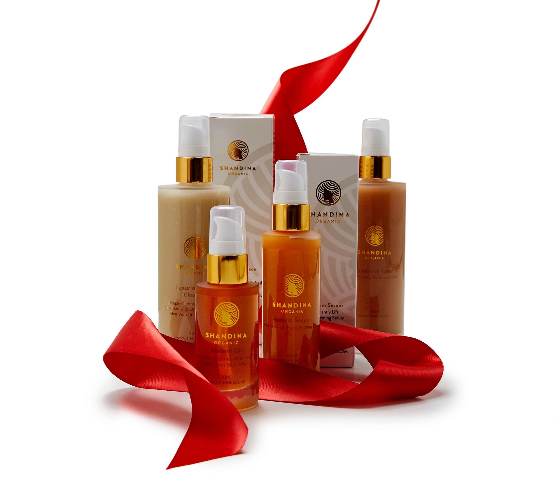 A group of bottles and boxes with a red ribbon around them