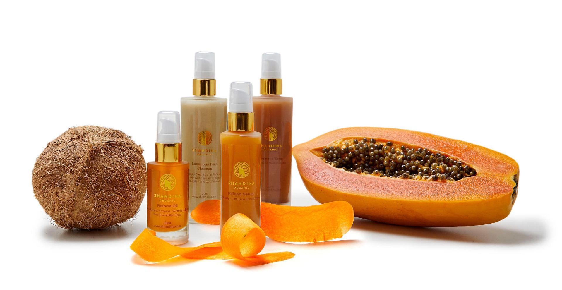 A group of bottles and a half of a papaya