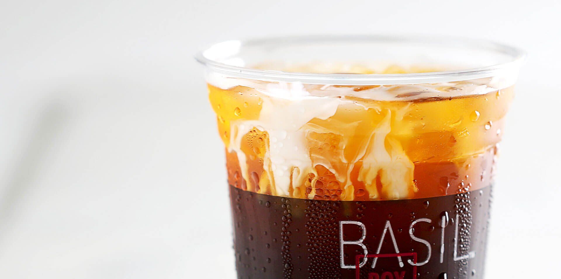 A close up of a cup of iced tea on a table.