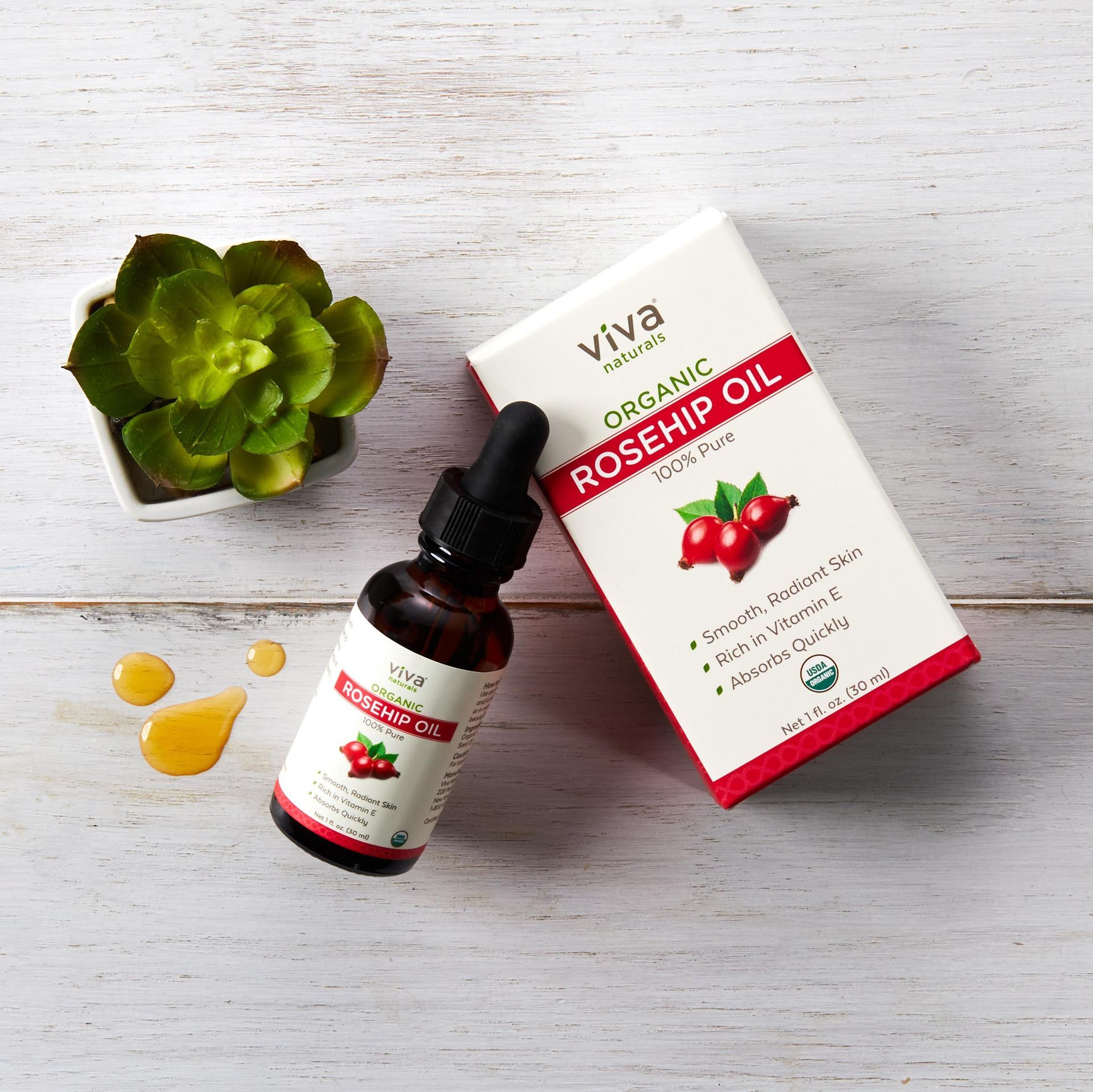 A bottle of organic rosehip oil next to a box