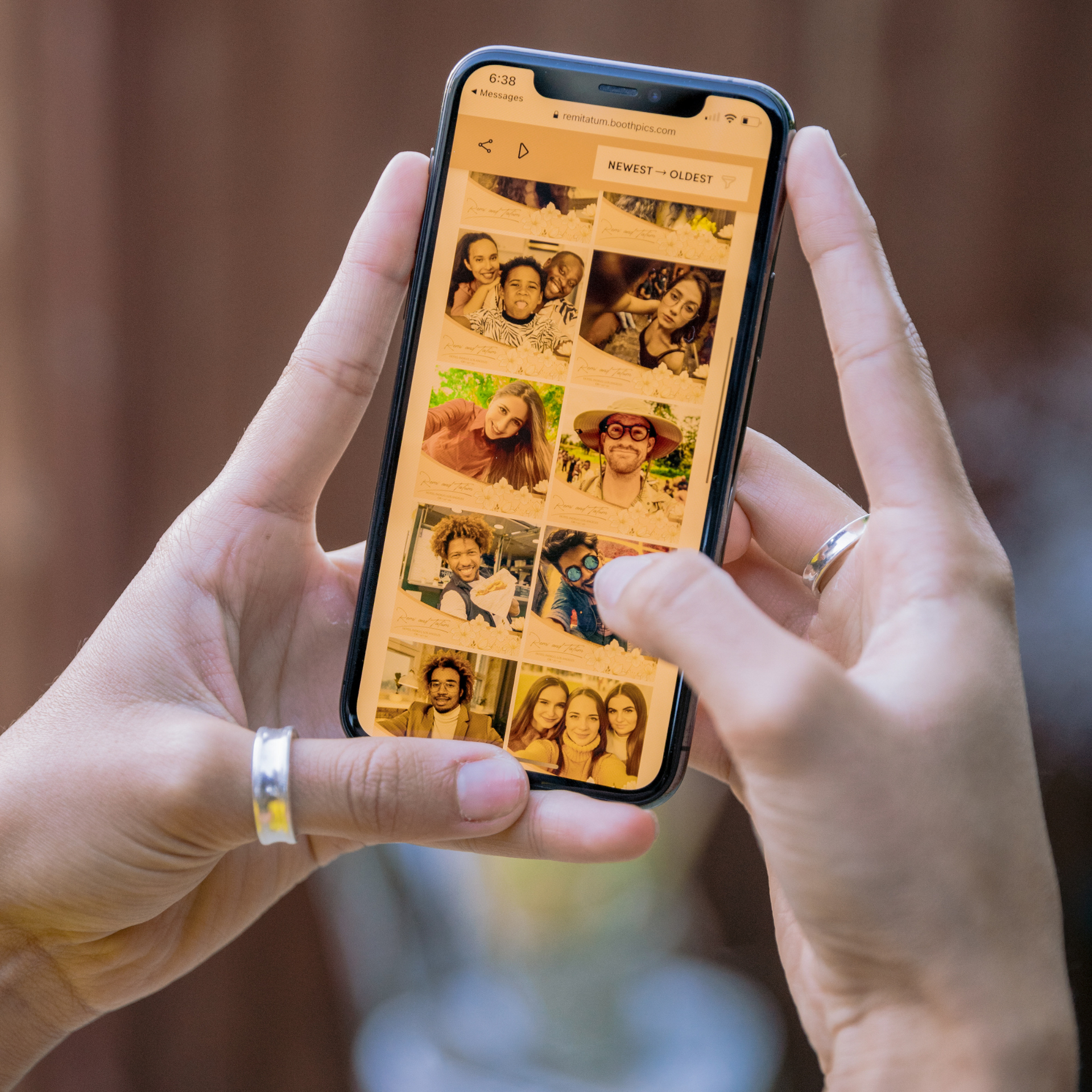A person is holding a cell phone with a bunch of pictures on it