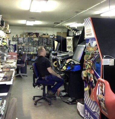 Arcade Partner — Man repairing arcade game in San Marcos, CA