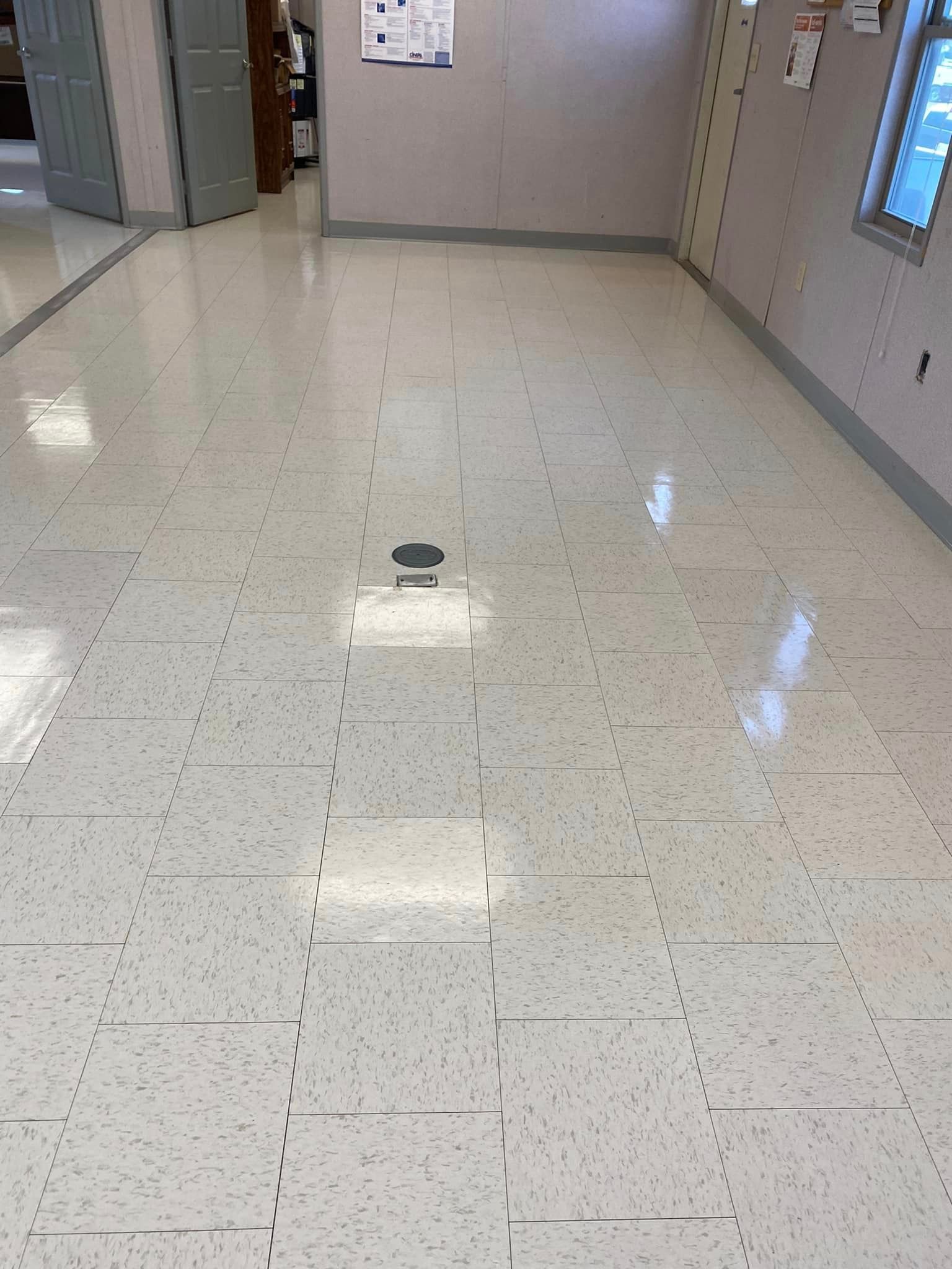 A room with a white tile floor and a window.