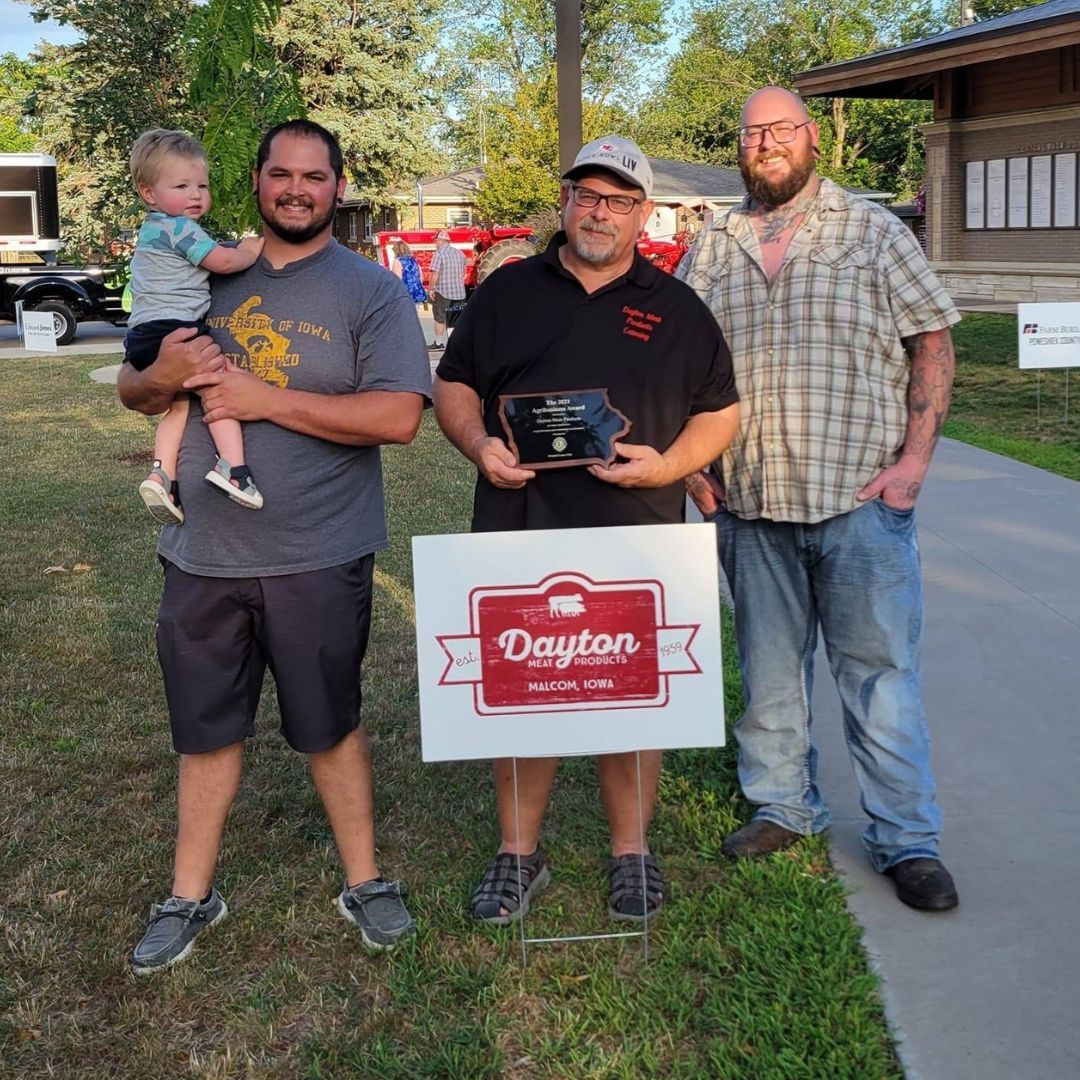 A group of men standing next to a sign that says dayton