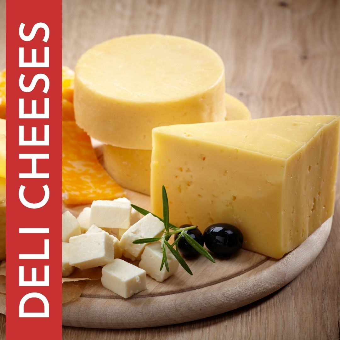 Slices of cheese on a wooden cutting board with the words deli cheeses on the bottom